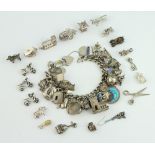 A silver charm bracelet and a quantity of silver charms 218 grams