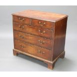 A Georgian mahogany chest of 2 short and 3 long drawers with brass swan neck drop handles, raised on