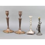 A pair of 19th Century Adam style candlesticks raised on spreading feet 30cm x 16cm x 12cm (once