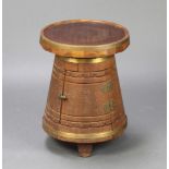 A circular coopered oak drinks cabinet in the form of a barrel with hinged front, raised on