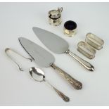 A pair of silver napkin rings Birmingham 1941, a pair of tongs, spoon and condiments 154 grams