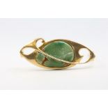 A 15ct yellow gold and jade brooch, a tiger's eye brooch