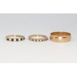 A 9ct yellow gold wedding band, size W, 3.9 grams and 2 9ct gold gem set rings sizes N and P 4.6