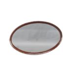 An Edwardian oval plate wall mirror contained in a mahogany frame 57cm h x 92cm w Silvering to the