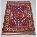 A red, blue and white ground Ghalmri Kilim rug with central medallion 197cm x 138cm Some light