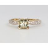 A 9ct yellow gold peridot and diamond ring 2.1 grams, size R 1/2