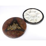 A Japanese 9 piece hors d'oeuvres set decorated with birds enclosed in a circular lacquered box