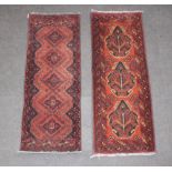 Two similar brown and black ground machine made rugs 149cm x 53cm