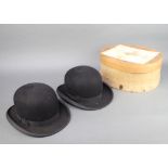 Dunn & Co, a gentleman's light weight bowler hat and 1 other complete with hat box