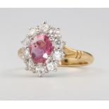 An 18ct yellow gold oval ruby and diamond cluster ring, centre stone approx. 1.5ct, diamonds 1ct,