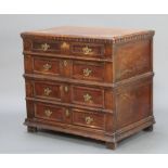 An 18th Century Continental oak chest of 4 drawers with geometric mouldings, raised on square