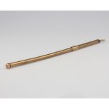 A 9ct yellow gold engine turned swizzle stick 5 grams