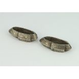 A pair of Persian silver floral engraved oval lozenges 6cm, 134 grams
