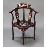 A Chinese hardwood and inlaid mother of pearl slat back corner chair, raised on turned supports with