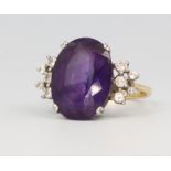 An 18ct yellow gold oval amethyst and diamond dress ring, 6.3 grams, size M