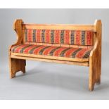 A Victorian style pine settle with upholstered seat and back 97cm h x 145cm w x 49cm d