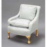 A Georgian style armchair upholstered in turquoise material and raised on gilt painted cabriole ball