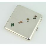 A 900 standard silver cigarette case with enamelled decoration depicting a 4 leaf clover, pig, daisy