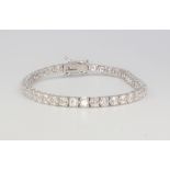 An 18ct white gold diamond tennis bracelet, comprising 43 diamonds approx. 7.6ct, 16.5cm