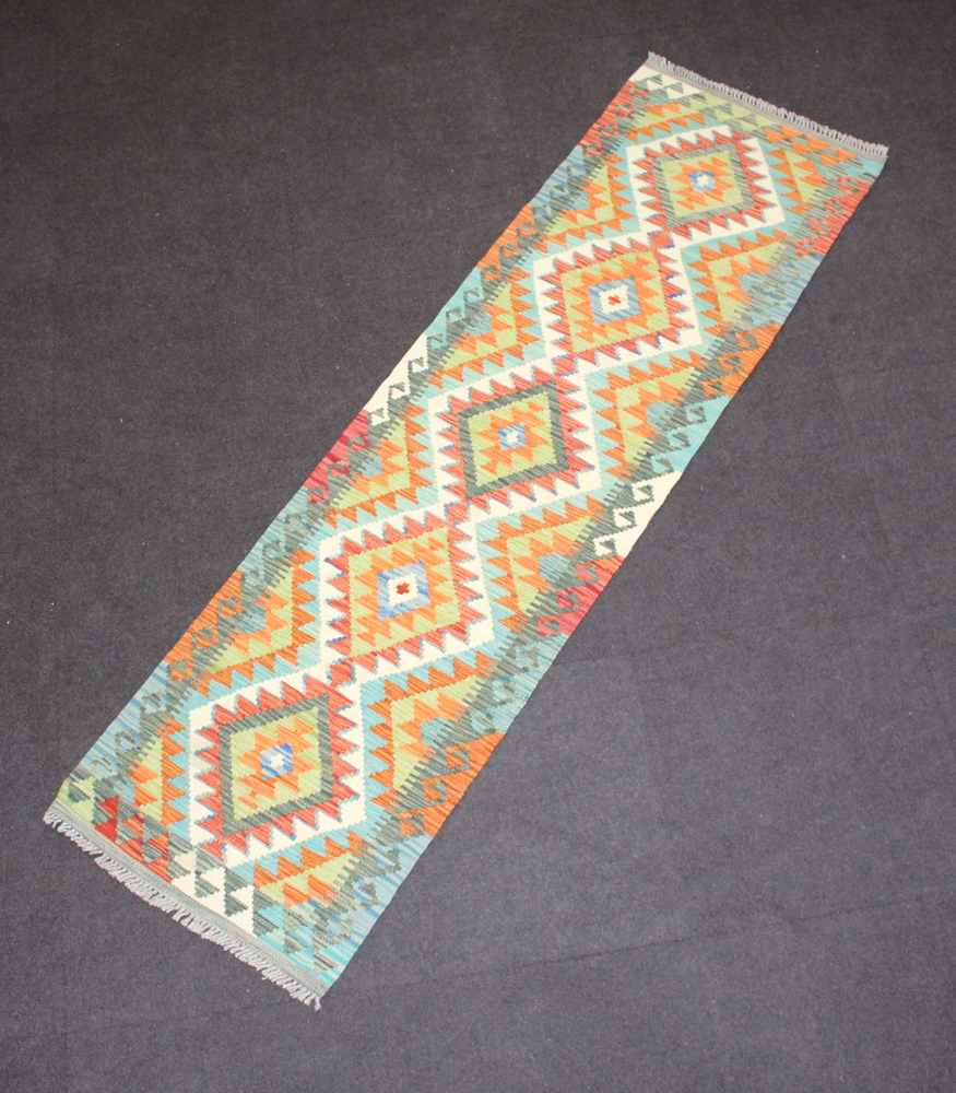 A green, white and brown ground Chobi Kilim runner with 5 diamonds to the centre 204cm x 57cm