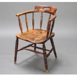 A 19th Century elm and beech tub back chairs raised on turned supports with double H frame stretcher