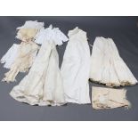 A child's white cotton double breasted jacket, a white cotton dress and other items of clothing