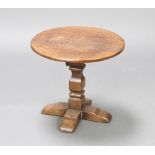 A circular oak occasional table raised on a square column and cruciform base 40cm h x 45cm diam.Some