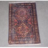 A red and blue ground Belouche rug within multi row border 134cm x 85cm The carpet is showing