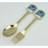 A Danish silver gilt and enamelled spoon and fork by A Michaelson 94 grams, dated July 1977
