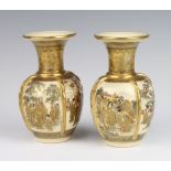 A pair of Satsuma Meiji period baluster vases with flared necks decorated with panels of pavilion