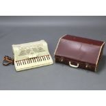 An Ariston piano accordion with 120 bass buttons, 2 treble couplers and 41 keys, cased