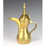 A Turkish brass coffee pot, having a heart shaped stamp to both sides of the main body 31cm h