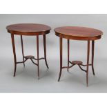 A pair of Edwardian oval inlaid mahogany 2 tier occasional tables, raised on outswept supports