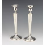 A pair of Sterling silver tapered candlesticks with engraved monogram 25cm These sticks have some