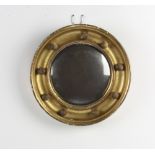 A 19th Century circular convex plate mirror contained in a gilt ball studded frame 20cm diam.