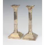 A pair of Victorian silver Corinthian column candlesticks on stepped bases Sheffield 1899, 22cm