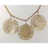 A 9ct yellow gold necklace with 3 carved mother of pearl pendants decorated with figures