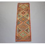 A yellow, green and white ground Chobi Kilim runner having 5 diamonds to the centre 198cm x 62cm