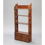 A Regency style mahogany 4 tier bookcase with fretted panels to the side, the base fitted 4 short
