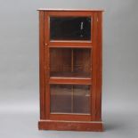 A 19th Century pine D shaped cabinet, fitted shelves enclosed by glazed panelled doors, raised on