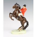 A Beswick figure of a rider on a rearing brown glazed horse 868 26cm