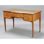 An Edwardian bow front inlaid mahogany writing table with green inset leather writing surface