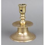 A 17th/18th Century polished bronze bell shaped candlestick raised on a spreading foot 14cm h x 14cm