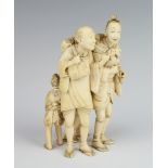 A Japanese Meiji period carved ivory okimono of 2 pipe smoking gentleman with 2 children playing