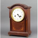 An Edwardian Art Nouveau striking bracket clock with enamelled dial and Arabic numerals contained in