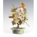 A Chinese soapstone flower group in a ditto jardiniere 30cm