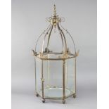 A Regency gilt metal hexagonal hanging hall lantern raised on bun feet with hinged opening door 77cm