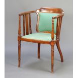 An Edwardian inlaid mahogany tub back chair with upholstered seat and back, raised on turned