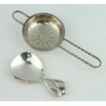 A stylish sterling silver caddy spoon together with a tea strainer 80 grams