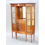 An Edwardian inlaid mahogany display cabinet with inlaid apron above a niche and arch bevelled plate